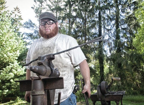 Blacksmith feels at home with hammer and anvil